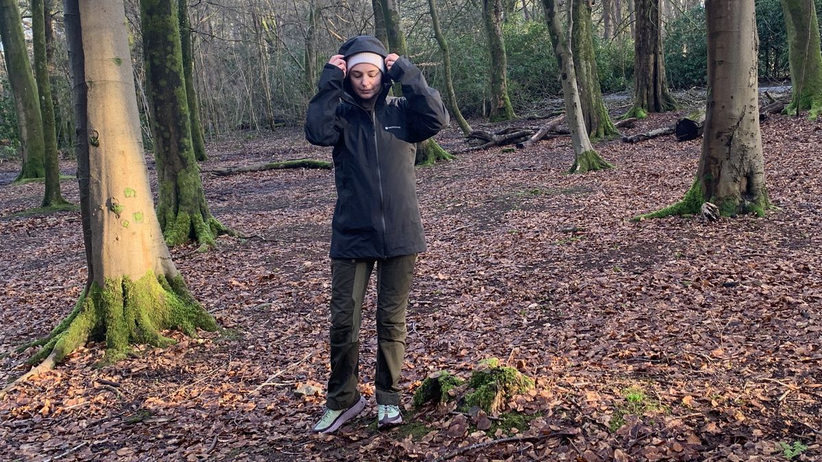 Julia Clarke wearing the Montane Solution Jacket in the forest