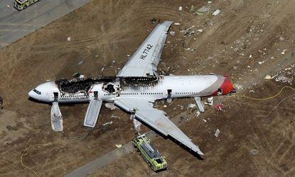 An Asiana Airlines passenger airplane lies burned on the runway after it crash landed at San Francisco International Airport July 6 in San Francisco. 