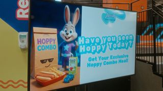 A Samsung display with a rabbit presenting a kids meal.