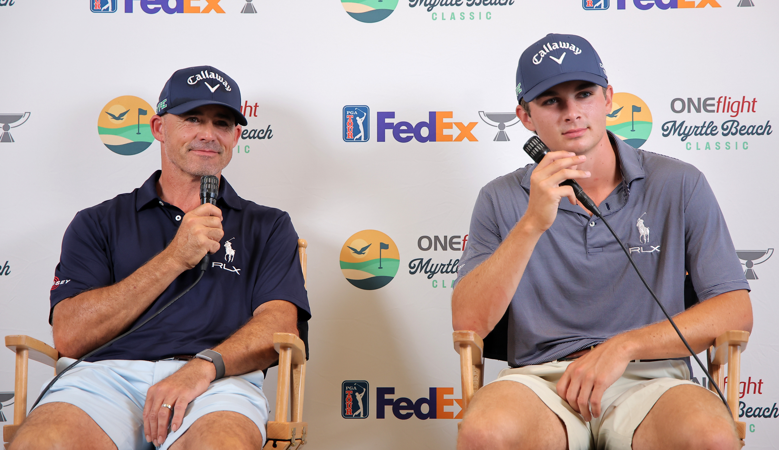 Jonathan Byrd and Jackson Byrd chat during a press conference