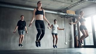 Men and Women skipping in a gym