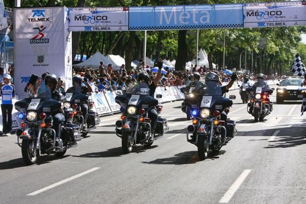 Mexican traffic police salute the crowd.