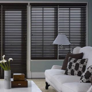 Premium Wood Blinds in a living room with a large sofa.