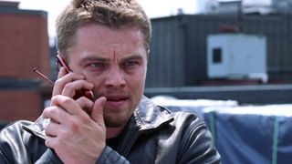 Leonardo DiCaprio as Trooper William "Billy" Costigan Jr. speaking into a cell phone with an angry expression during a scene in The Departed.