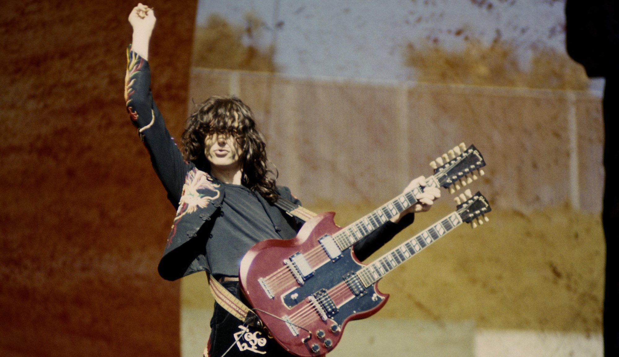 Jimmy Page performs onstage with Led Zeppelin at the Oakland Coliseum in Oakland, California on July 23, 1977