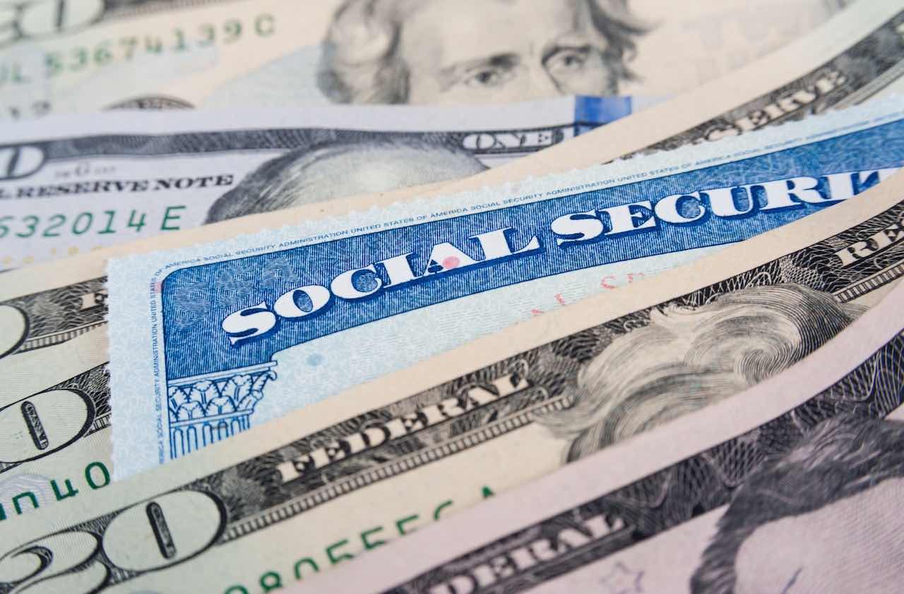 Social security card and American money dollar bills close up concept