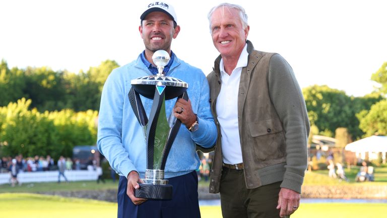Charl Schwartzel holds his trophy alongside LIV Golf CEO Greg Norman after the first LIV Golf Invitational Series event