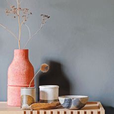 Wooden sideboard with vases and bowls curated on top