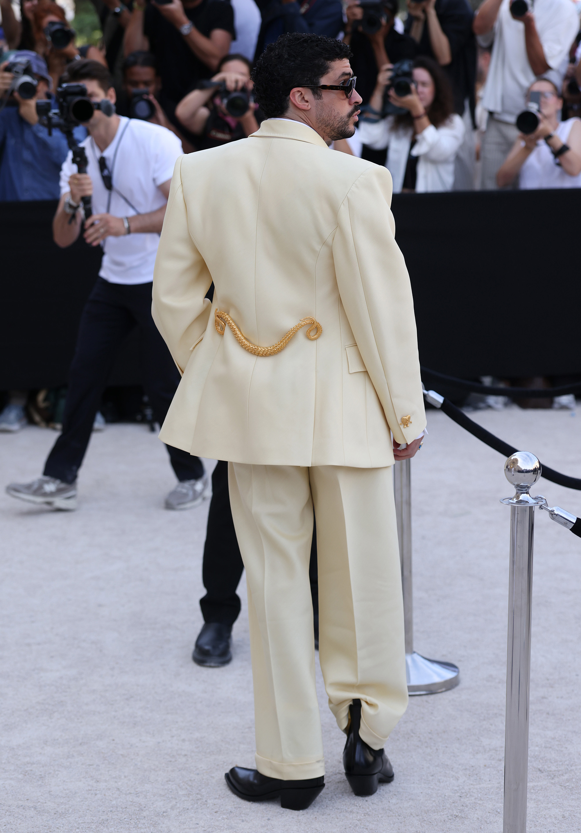 Bad Bunny in yellow Schiaparelli suit with gold trim and black shoes 2026.