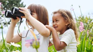 Two Girls with Binoculars in High Grass