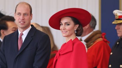 Kate Middleton's red cape seen as she and Prince William attend a ceremonial welcome for The President and the First Lady of the Republic of Korea
