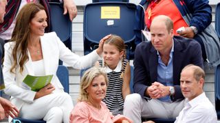 Princess of Wales, Princess Charlotte, Prince William and the Duchess and Duke of Edinburgh sit down to watch a hockey match during the 2022 Commonwealth Games