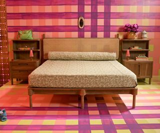Pink purple and yellow plaid wallpaper and floor, wooden bedframe