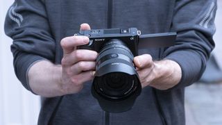 Two hands holding the Sony ZV-E1 camera