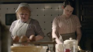 Lesley Nicol and Sophia Mcshera work together in the kitchen in Downton Abbey.