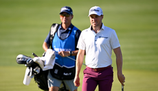 Justin Thomas walks alongside his caddie during The American Express