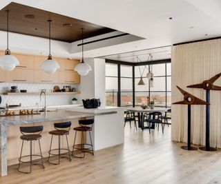 Morrison Interiors kitchen with pale wood floor and vintage wooden sculpture