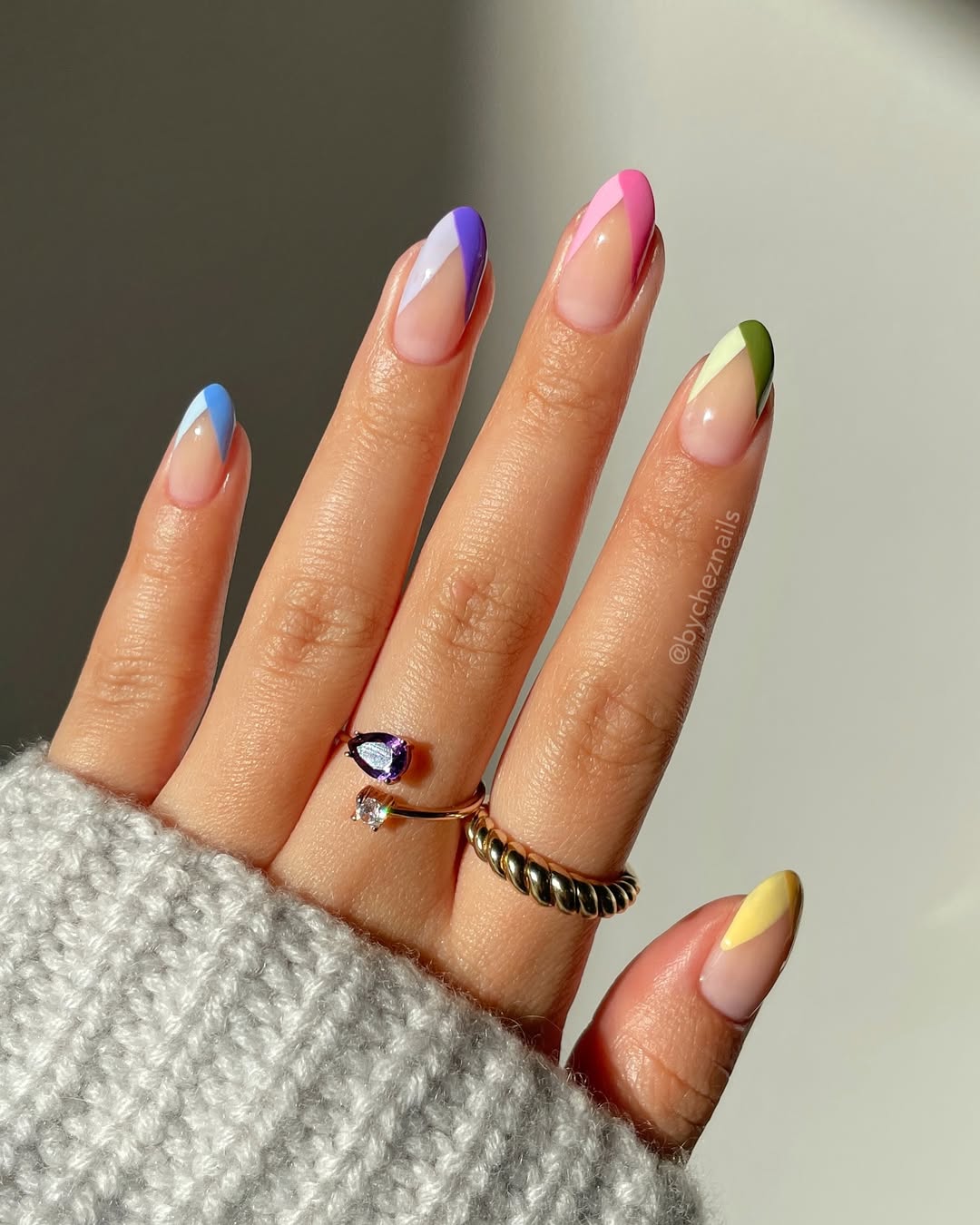 a french manicure with rainbow color blocks