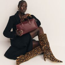 Reformation model wearing leopard-print boots