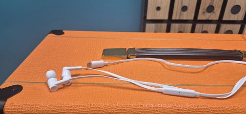 Belkin SoundForm Wired Earbuds with USB-C Connector on top of an orange amp