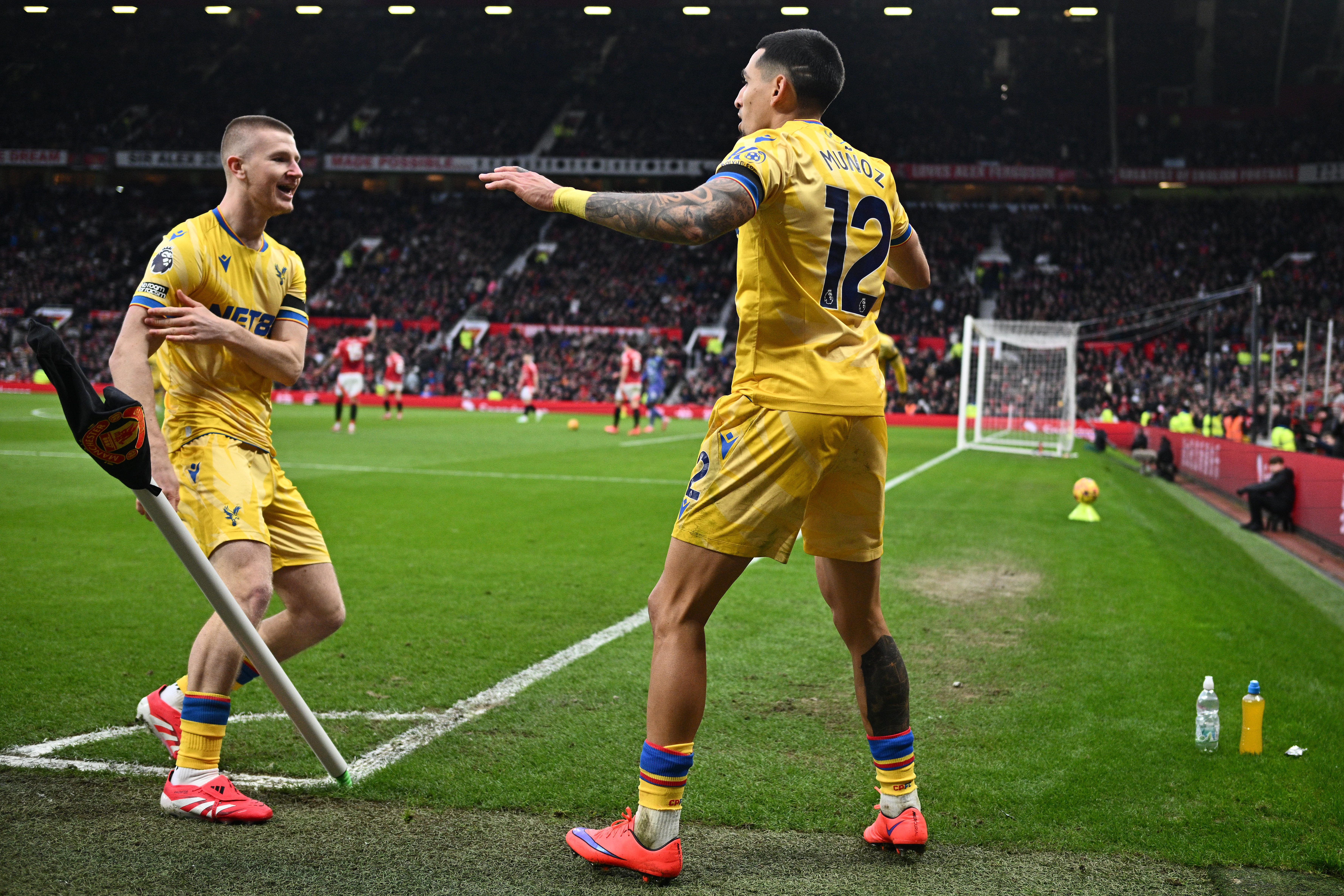 Adam Wharton and Daniel Munoz celebrate a goal for Crystal Palace against Manchester United at Old Trafford in the Premier League in February 2025.
