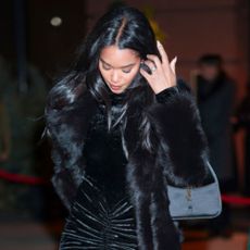 Laura Harrier wears Saint Laurent's 'Le 5 à 7' bag February 05, 2025 in New York City.