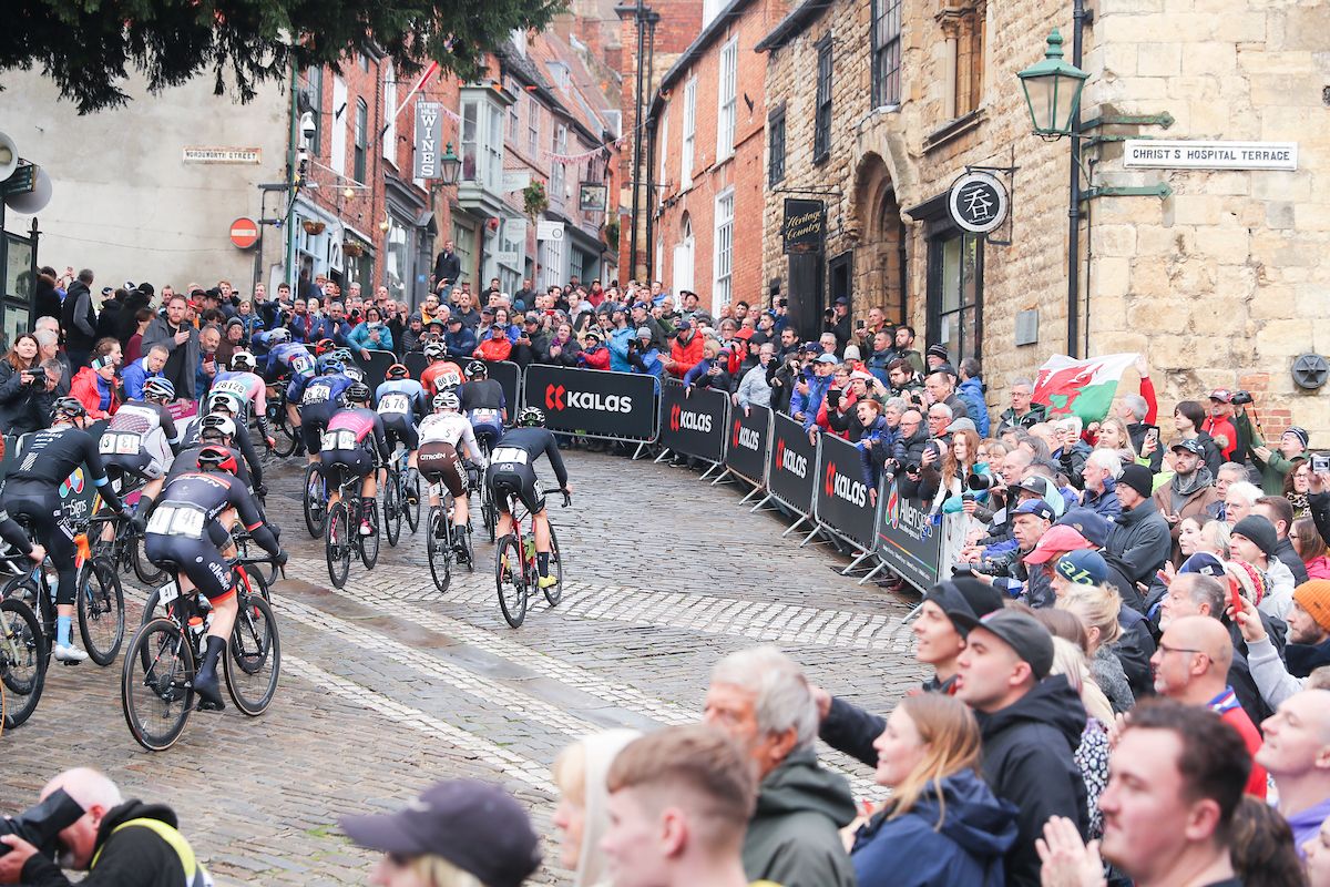 Picture by Alex Whitehead/SWpix.com - 17/10/2021 - Cycling - Men's National Road Championships - Rapha Lincoln GP - Lincoln, England - The riders come to the top of the Michaelgate cobbles, Kalas, branding.