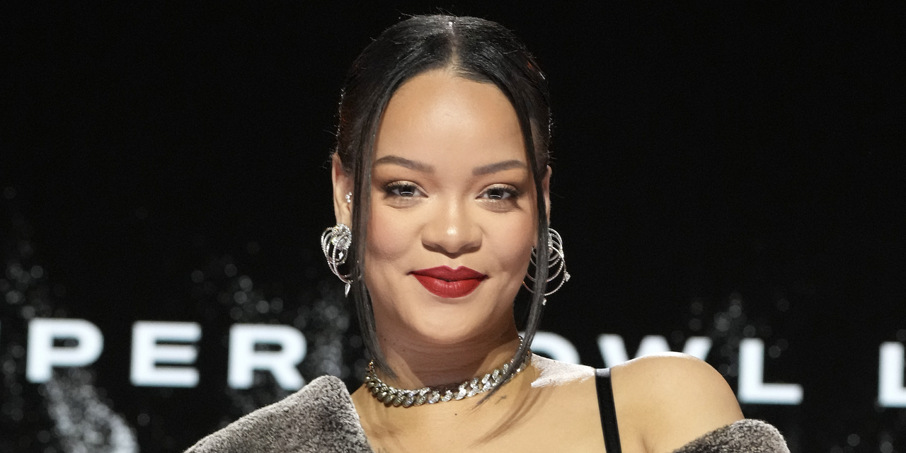 rihanna smiles wearing red lipstick