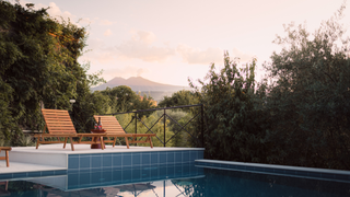 The pool at Palazzo Previtera with views of Mount Etna.