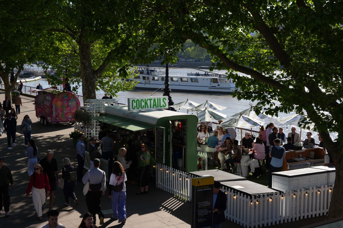 Busy South Bank cocktail bar terrace beside the River Thames.