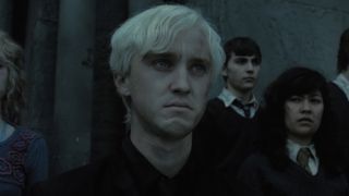 Tom Felton frowning when Draco's parent ask him to join them in the Battle of Hogwarts