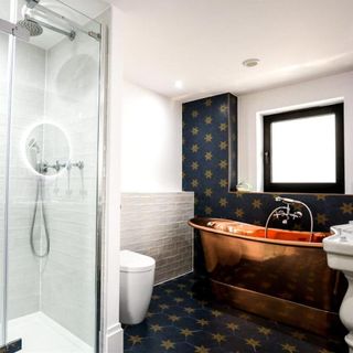 bathroom with shower area and bath tub
