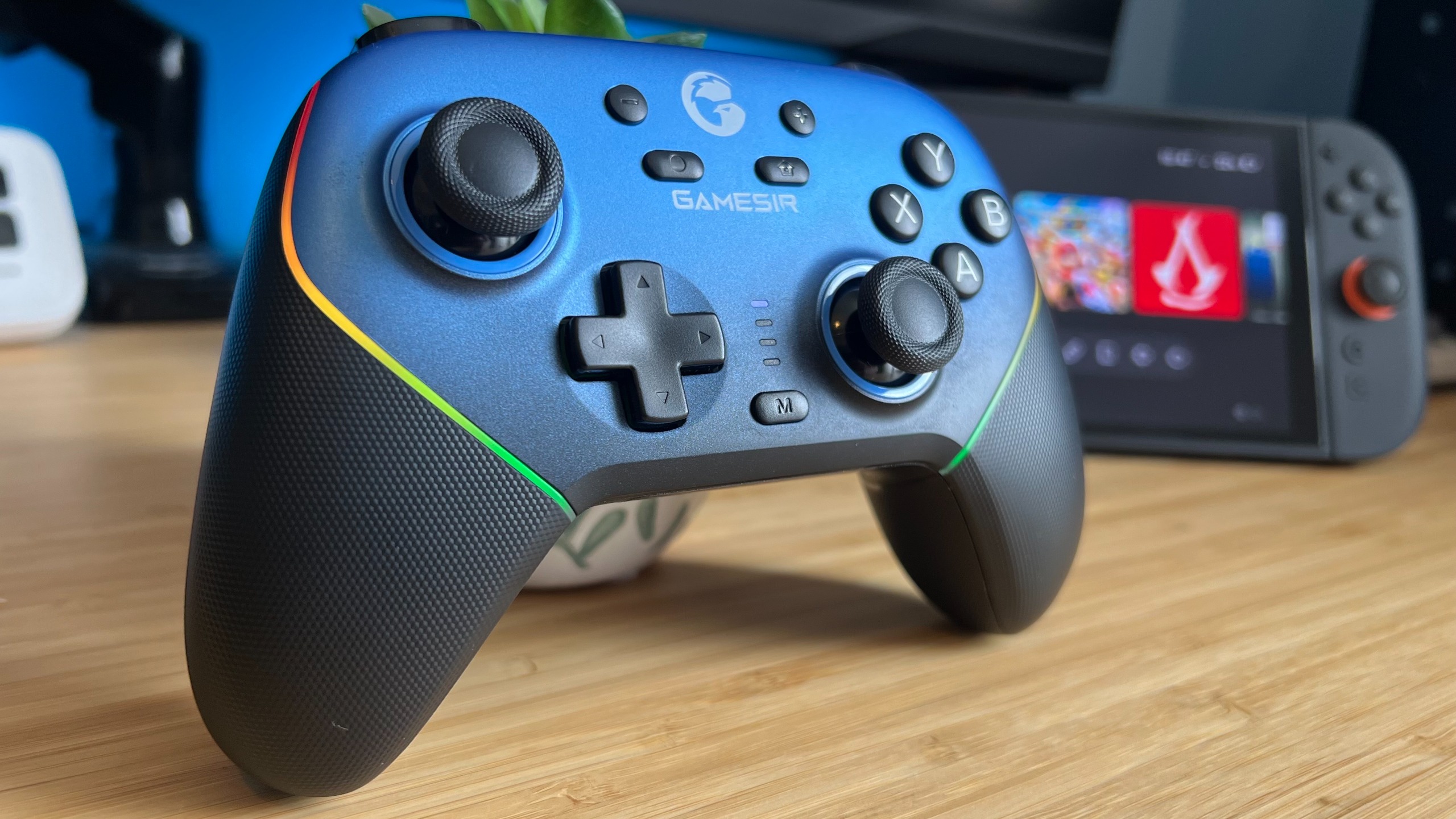 GameSir Super Nova controller on a wooden desk in front of a Nintendo Switch 2