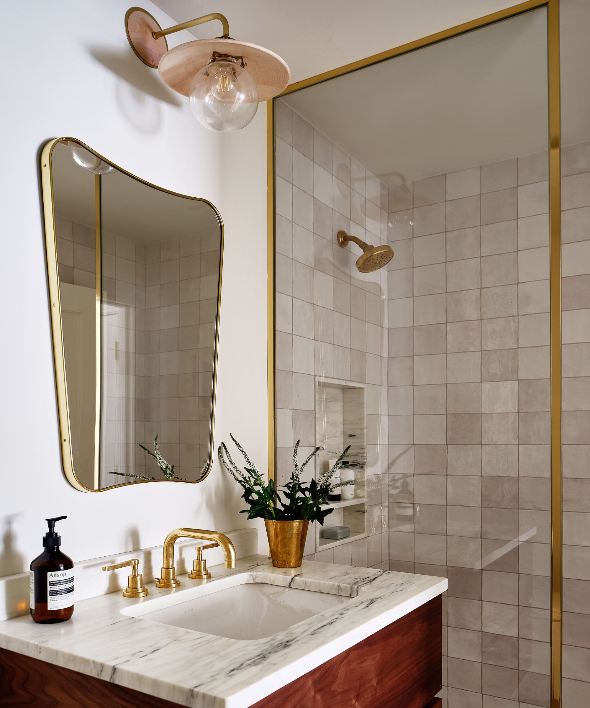 small bathroom with zellige tiles and marble vanity with modern mirror and wall sconce