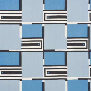 A fabric with a geometric patterned design in shades on blue.