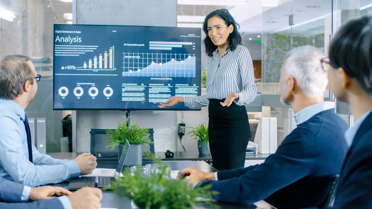 An executive gives a presentation to a board meeting