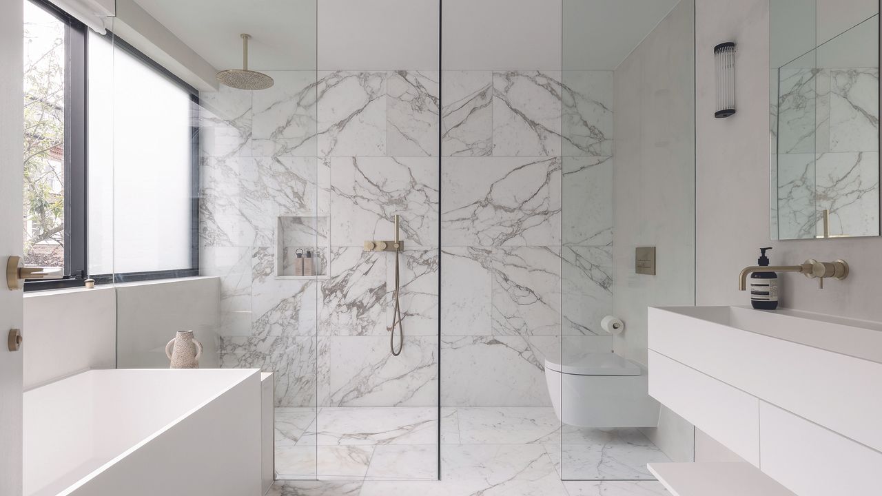 White modern bathroom with marble wall panels 