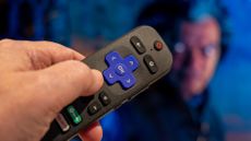 Roku remote control pointed at a TV