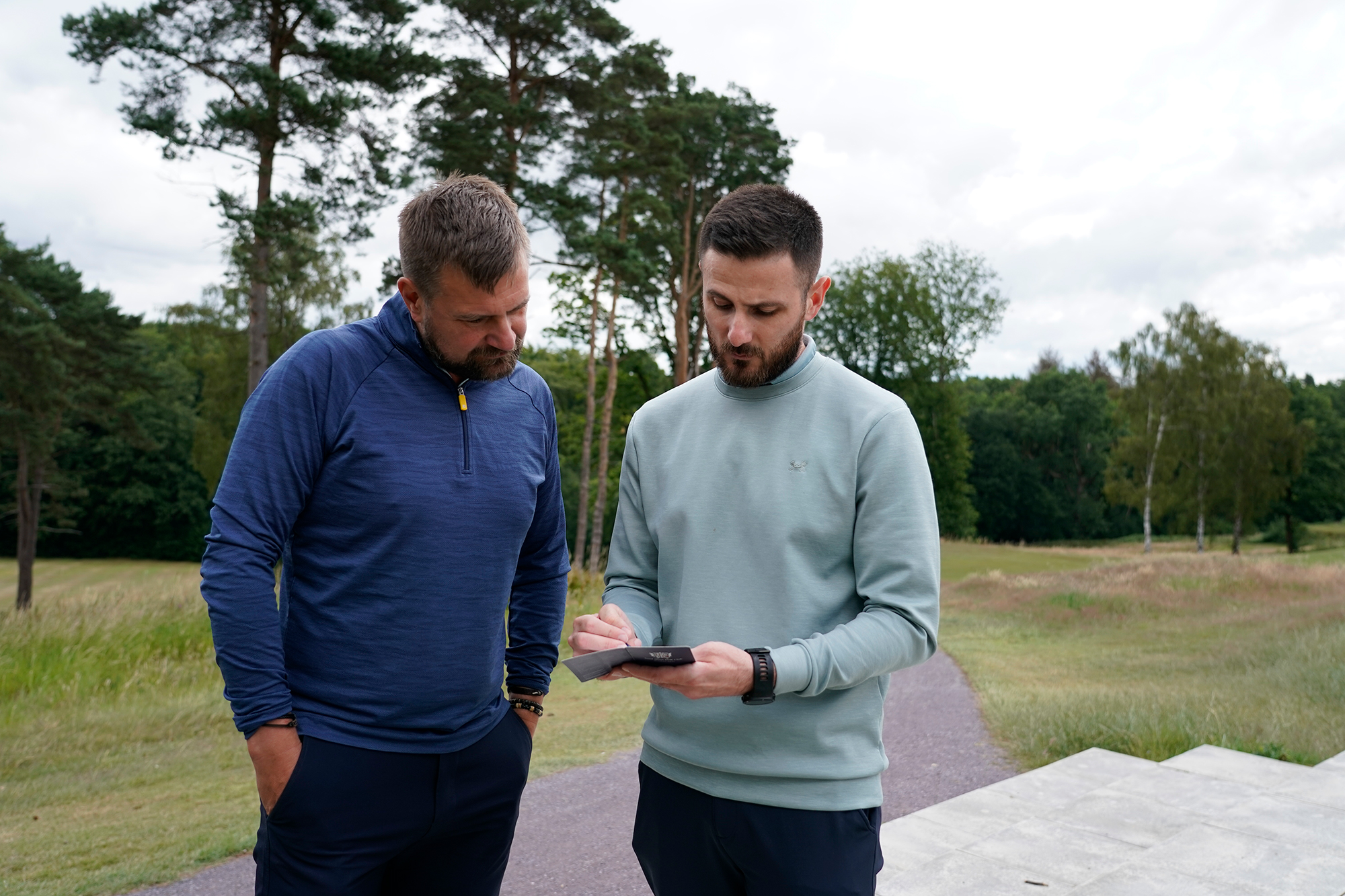 Baz Plummer and his coach Alex James collecting basic data of his playing lesson round of golf to inform their future tuition