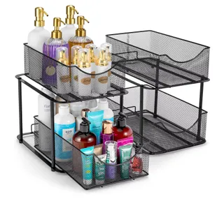 Two Black metal mesh 2 Tier Under Sink Organizers. One is empty, the other is packed with soaps and sprays