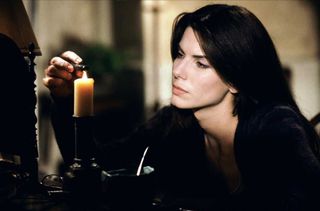 Sandra Bullock lights a candle in 'Practical Magic'