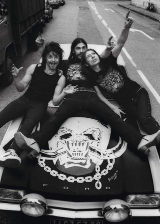 Motorhead lying on the bonnet of a Ford Capri