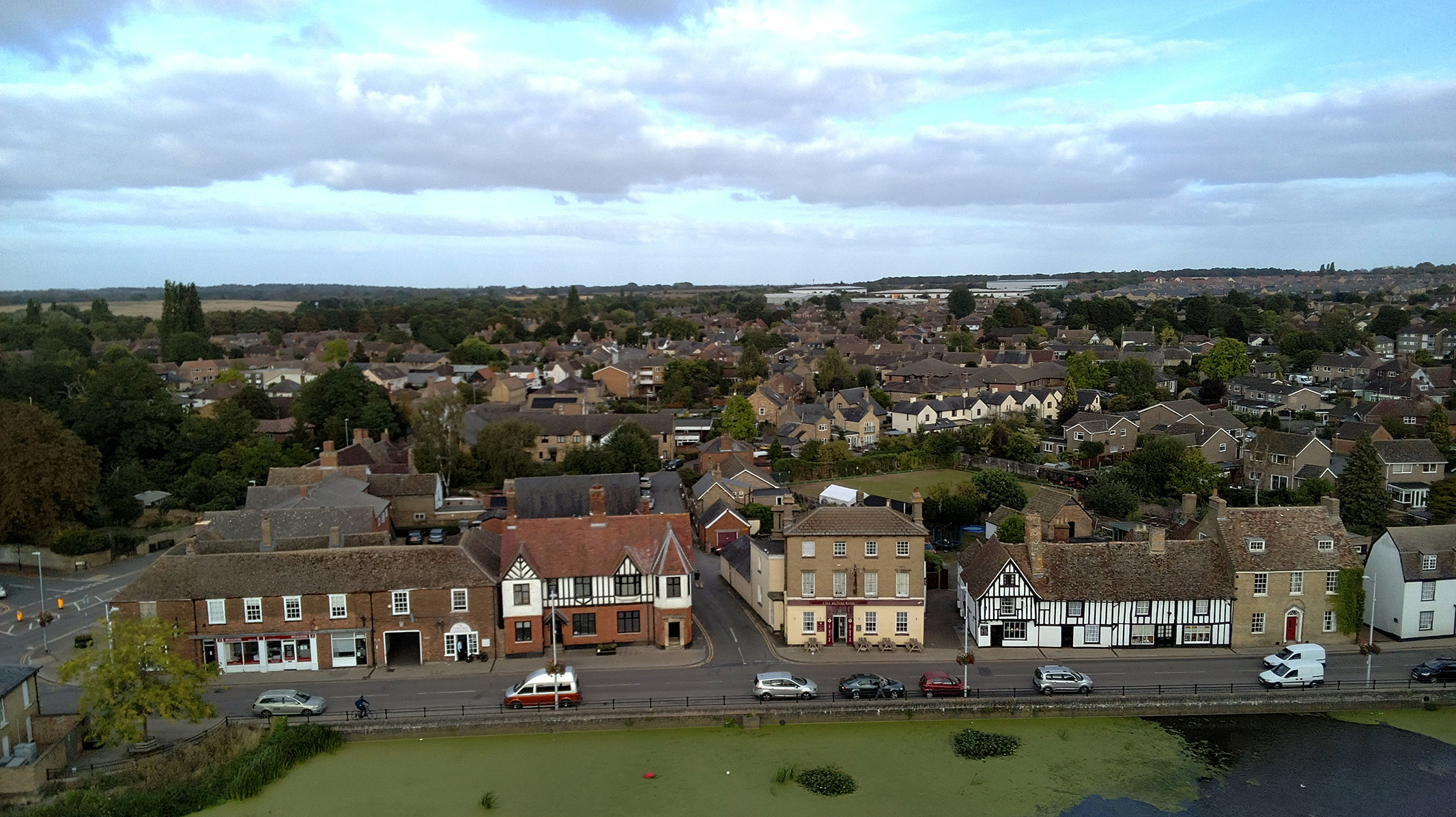 Photo of houses, a roud and a river taken with a Bwine F7GIM drone