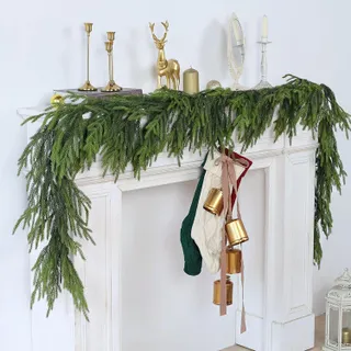 Faux pine garland draped above a mantle