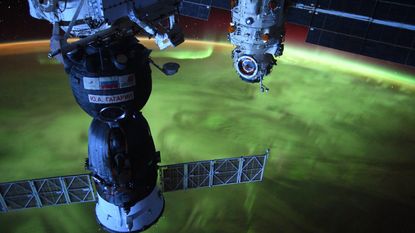 Photo taken from the ISS showing part of the station hovering above the northern lights