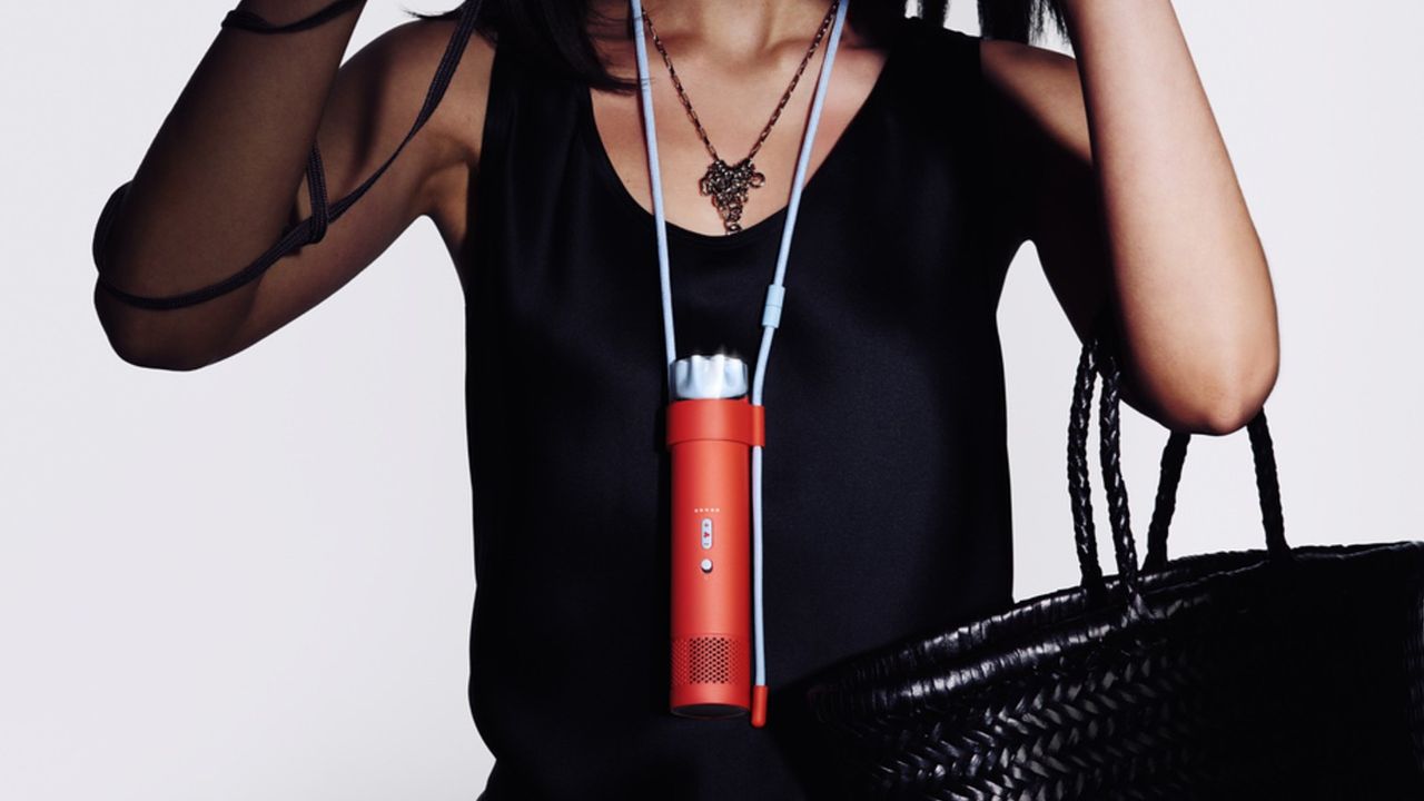 Person wearing Dyson HushJet Mini Cool Fan on cord around their neck