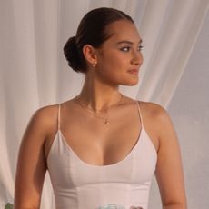 belly wears a white dress and smiles looking to the left in the summer i turned pretty