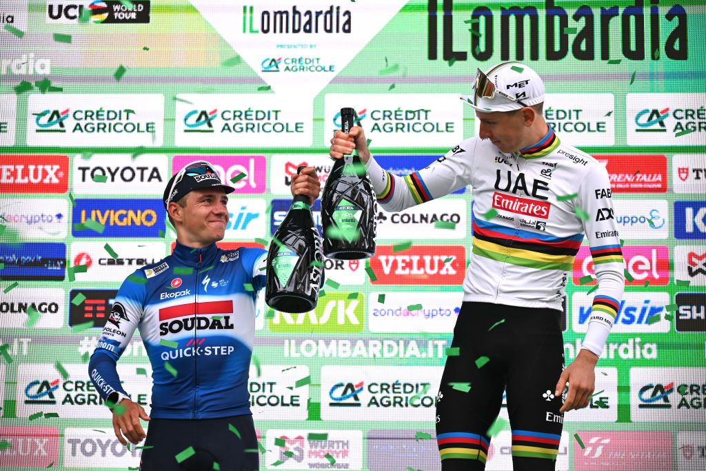 COMO ITALY OCTOBER 12 LR Remco Evenepoel of Belgium and Team Soudal QuickStep on second place and race winner Tadej Pogacar of Slovenia and UAE Team Emirates pose and celebrate on the podium ceremony after the 118th Il Lombardia 2024 a 255km one day race from Bergamo to Como UCIWT on October 12 2024 in Como Italy Photo by Tim de WaeleGetty Images