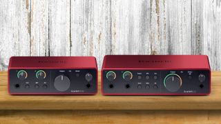 Two Focusrite Scarlett audio interfaces side by side on a wooden desk