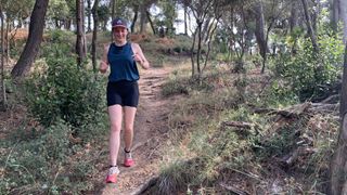 Woman jogging down trail wearing the Montane Women's Ineo Lite shorts